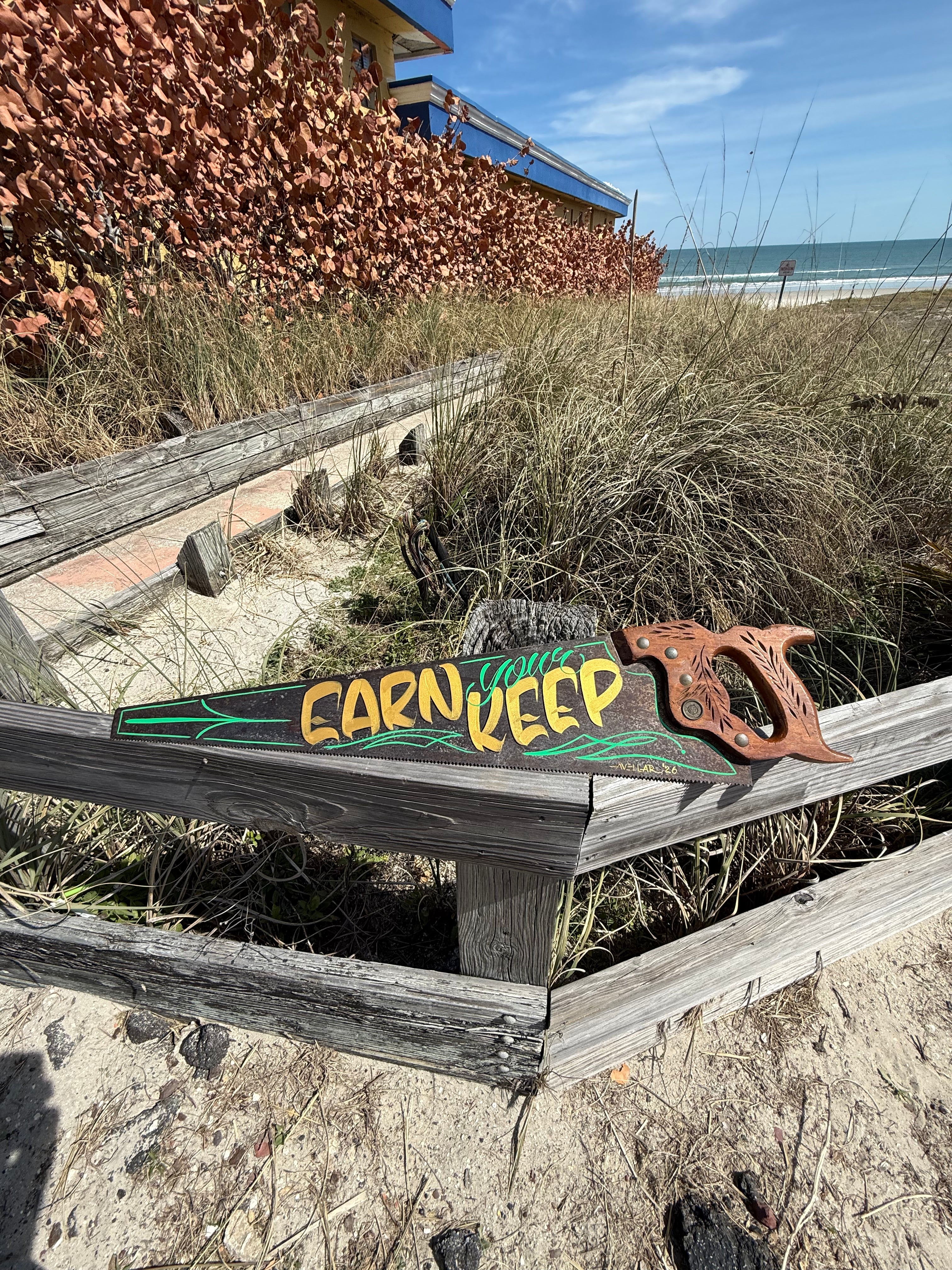 Earn Your Keep hand painted saw